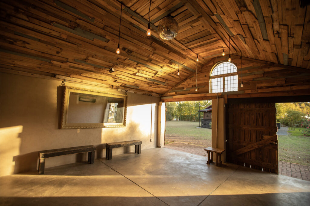 A barn-like event space with wooden ceiling and cozy lighting